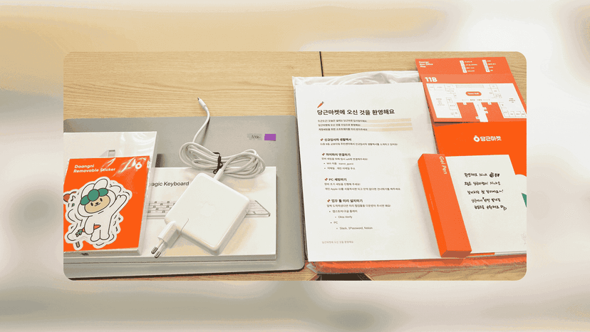 ALT: Banner image showing onboarding goods such as MacBook, charger, sticker, guide, etc.